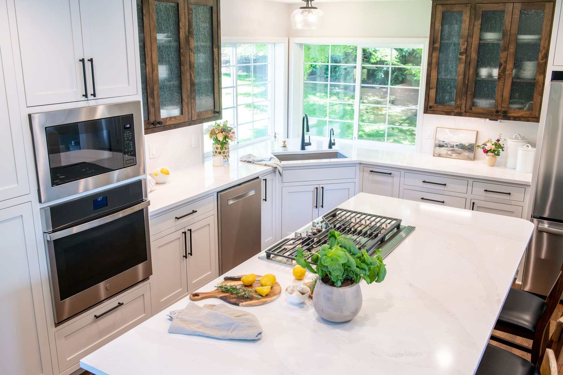 aerial shot of kitchen with island and stovetop, and white and brown cabinets in remodeled kitchen in Corvallis, Oregon by Corvallis Custom Kitchen & Baths