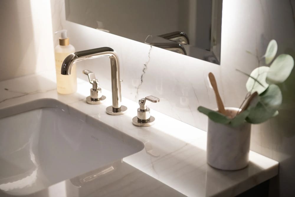 Sweet Home bathroom remodel sink detail with gold fixture